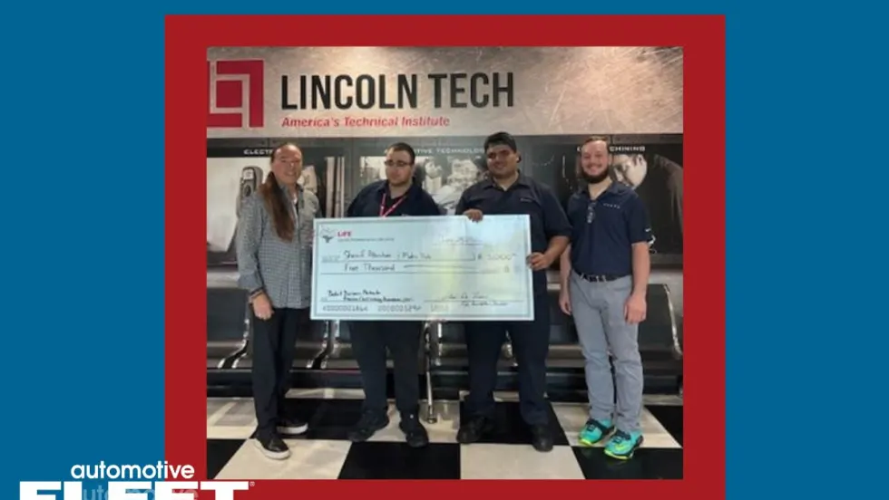 Four individuals stand holding a check honoring two students who won scholarships money at Lincoln Tech.