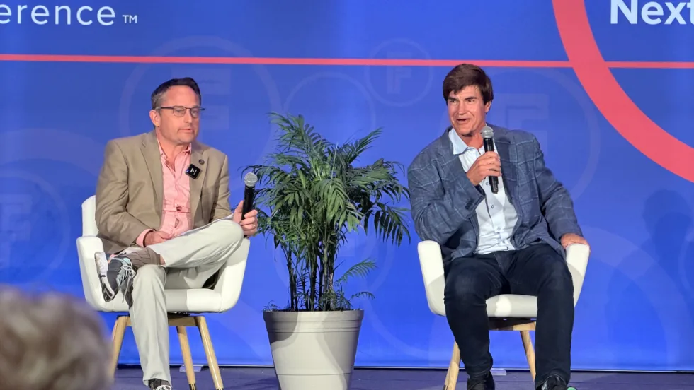 Ted Cannis and Chris Brown sit on the fleet forward stage, addressing future realities for fleets.