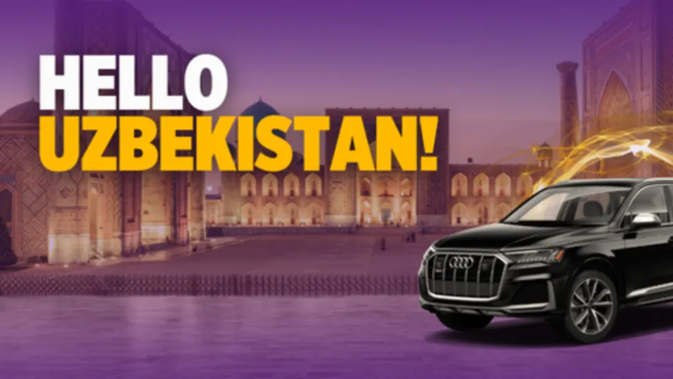 A black Audi SUV superimposed on a historic scene from downtown Tashkent, Uzbekistan.