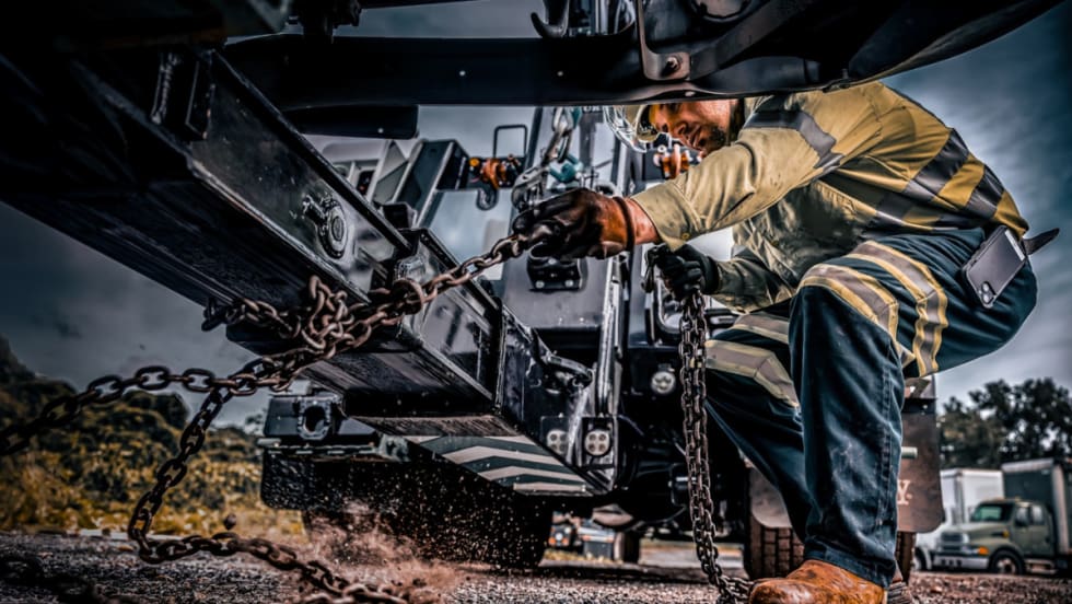 A man works on a Cox Fleet truck.