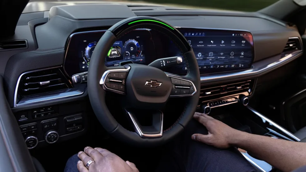 A driver sitting in the passenger seat of a 2025 Chevrolet Tahoe RST while Super Cruise pilots the vehicle.