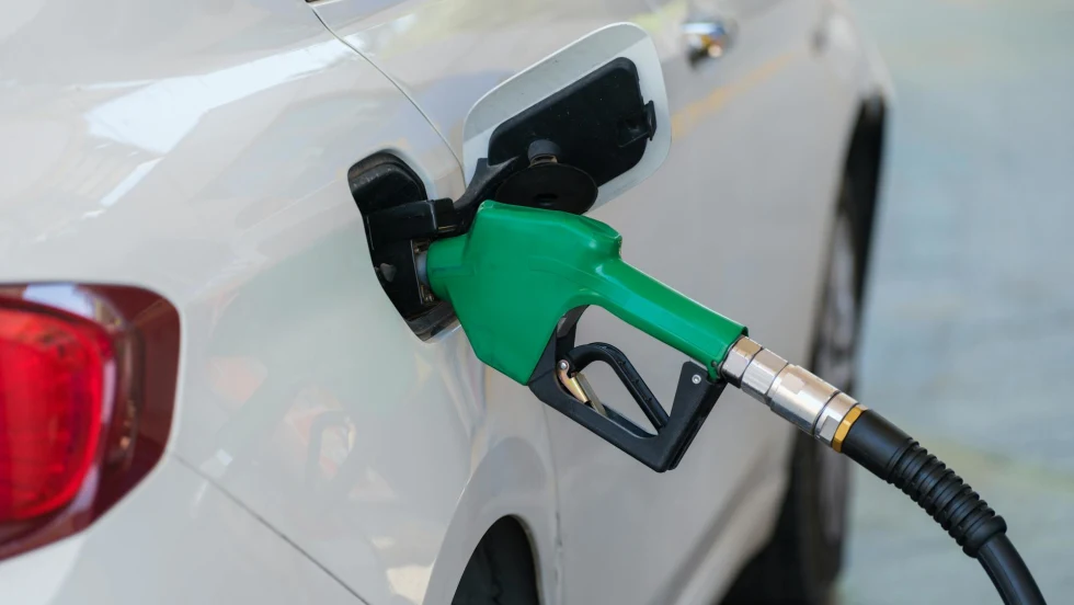 A while diesel car fueling with a green nozzle.