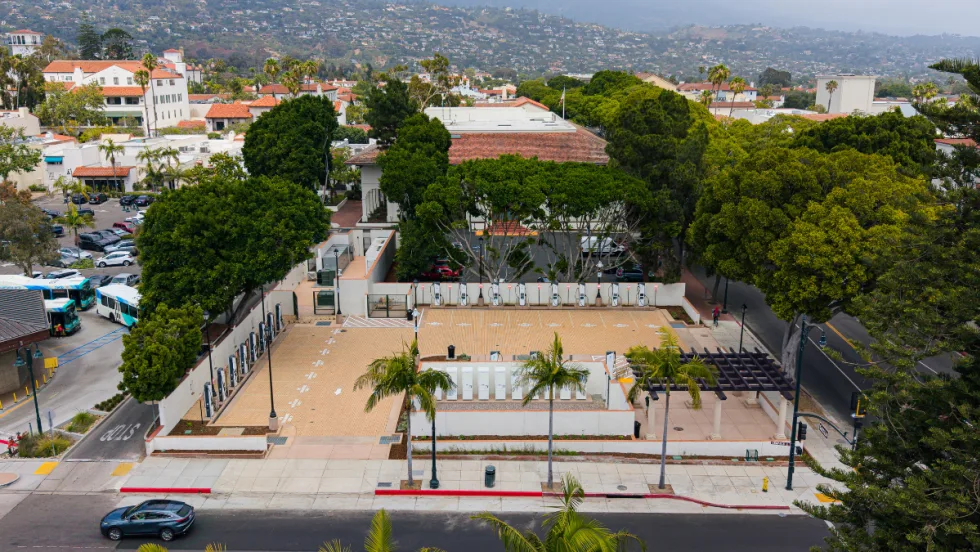 Overview of fast-charging depot in downtown Santa Barbara with panoramic view of coastal mountains and ocean in the background.
