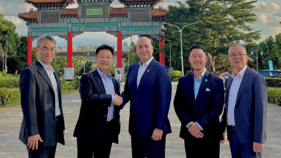 Enterprise executives pose in front of Taiwanese landmark.