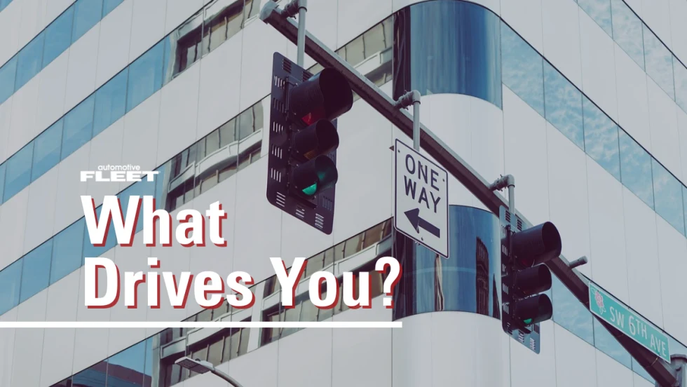 Image of a building and stop lights with text reading, "What Drives You?"