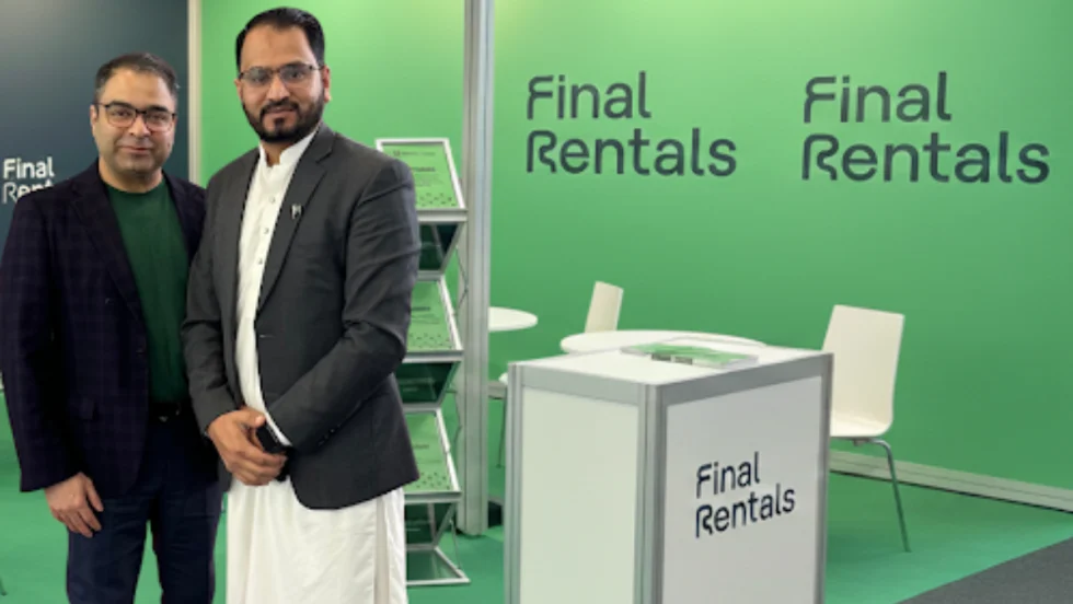 Final Rentals CEO Ammar Akhtar with Pakistani franchise owner Ahtsham Ali in front of a green-and-white car rental counter.