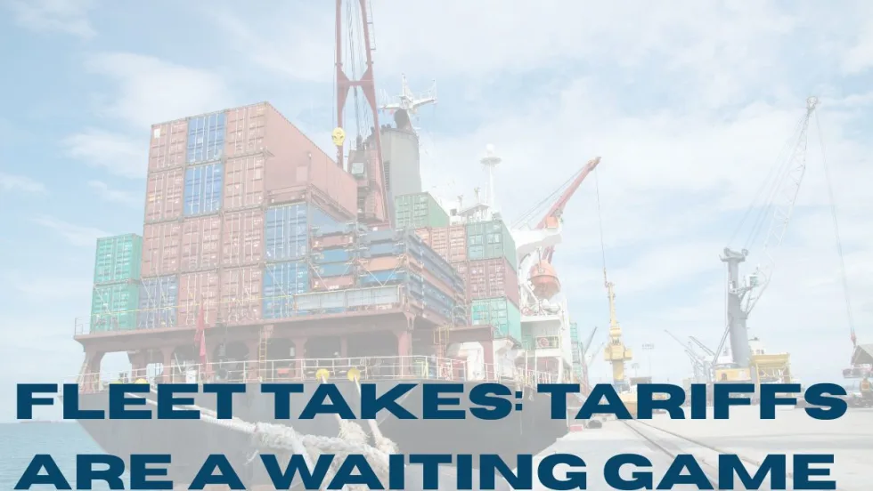 “A large cargo ship loaded with colorful shipping containers docked at a port, with cranes in the background. Bold headline text over the image reads: ‘Fleet Takes: Tariffs Are a Waiting Game.’”