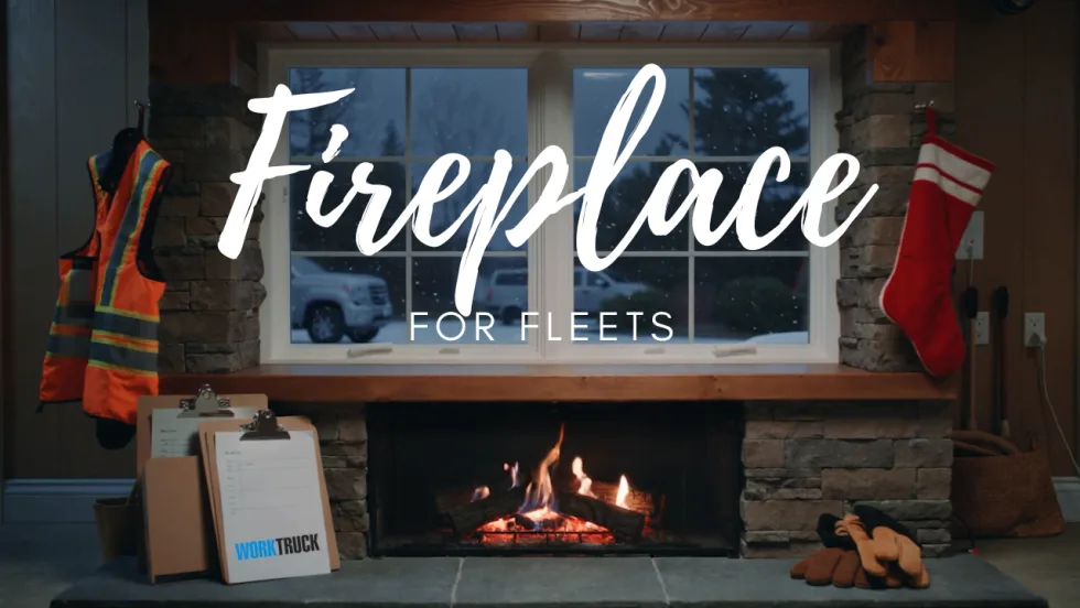 Fleet-themed fireplace with safety vest, clipboards, work gloves, and a crackling fire, designed to bring holiday warmth to fleet offices and maintenance shops.