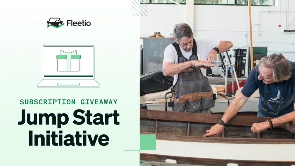 Two men working together on a wooden boat inside a workshop, alongside text for Fleetio’s Jump Start Initiative subscription giveaway