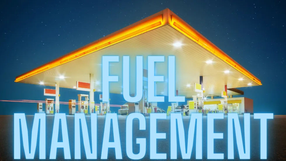 A fuel station at night with FUEL MANAGEMENT in large text.