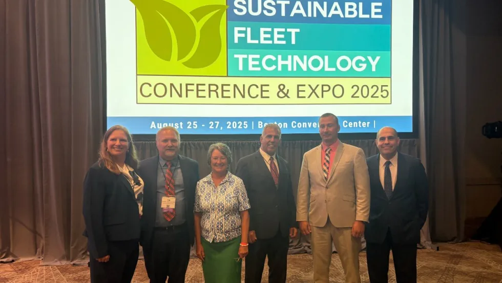 The Green Fleet Award Recipients pose in a line in front of a screen for this year's ceremony.
