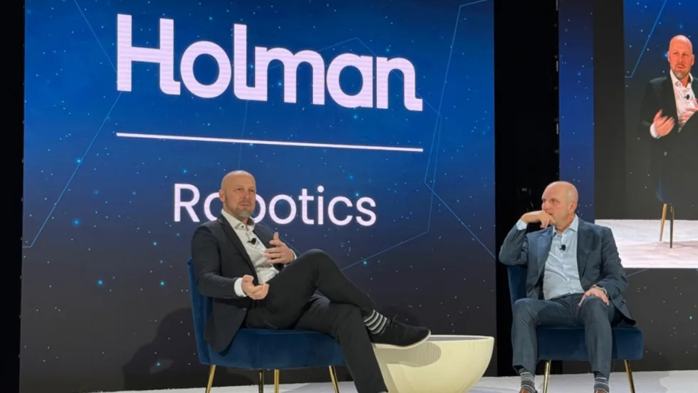 A photo of Homan CEO and vice president discussing the new robotics software at this year's conference.