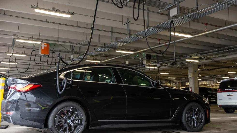 A black rental car is at a ChargePoint stations