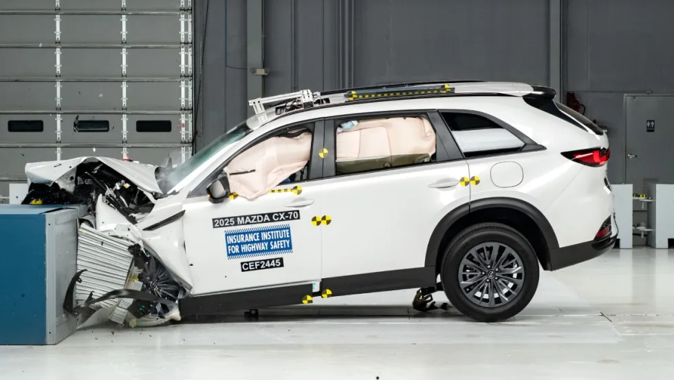 A white 2025 Mazda CX-70 during the updated moderate overlap front crash test.