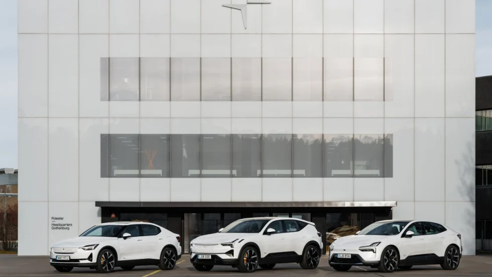An image of three white Polestar cars lined up in front of a Polestar company building.