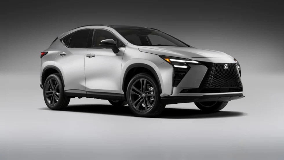 Silver 2027 Lexus NX compact crossover shown from the front three-quarter view. The updated lineup includes NX 350h hybrid and NX 450h+ plug-in hybrid models.