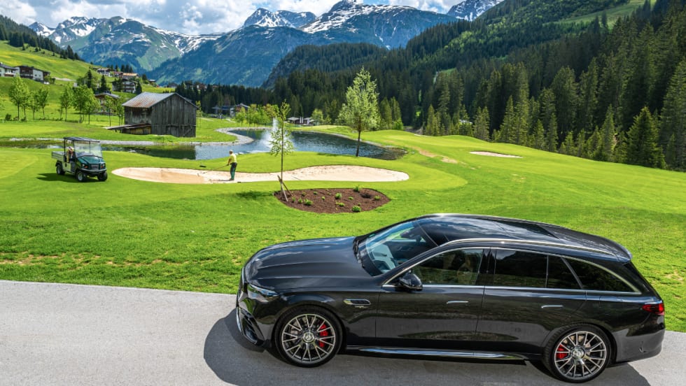 The European Mercedes Hybrid Wagon drives on a mountainside overlooking the landscape.