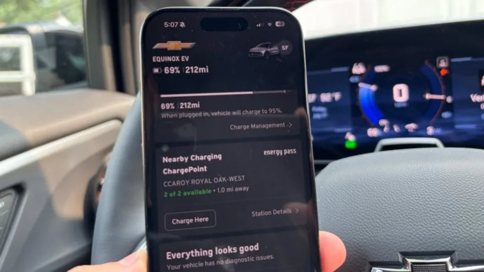 a hand holding a phone with the MyChevrolet Energy Pass chargin app open