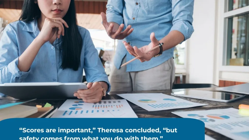 Two professionals in blue shirts reviewing charts and graphs on paper and tablet at a table; one person gestures with a pencil while the other listens, with a quote displayed on top.