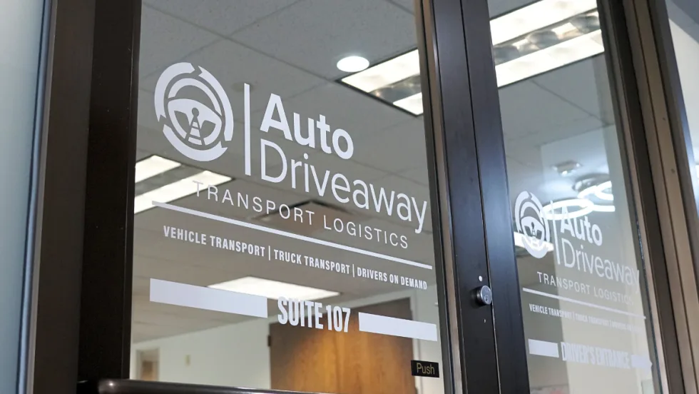 The business front to Auto Driveway with the company logo on the door.