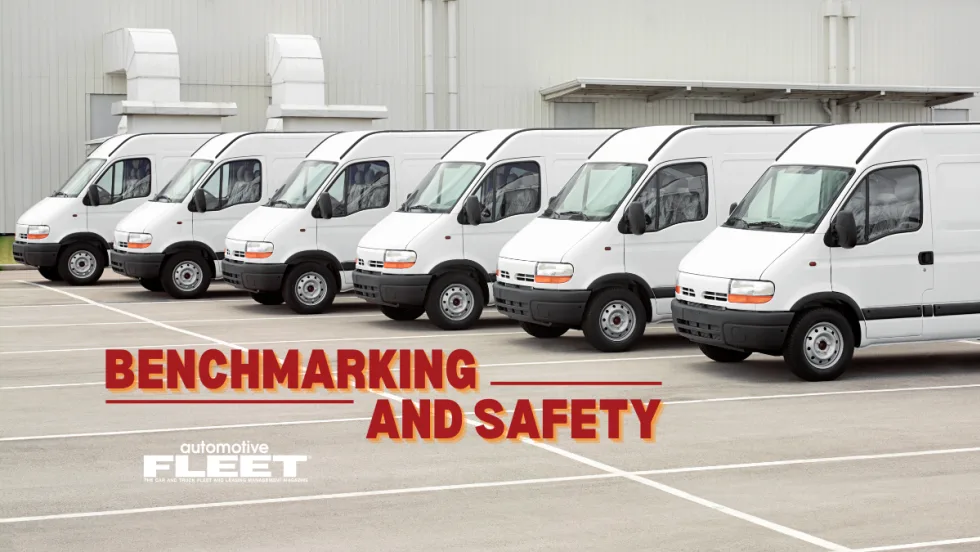A lineup of white fleet vans in a parking lot with the text "Benchmarking and Safety".