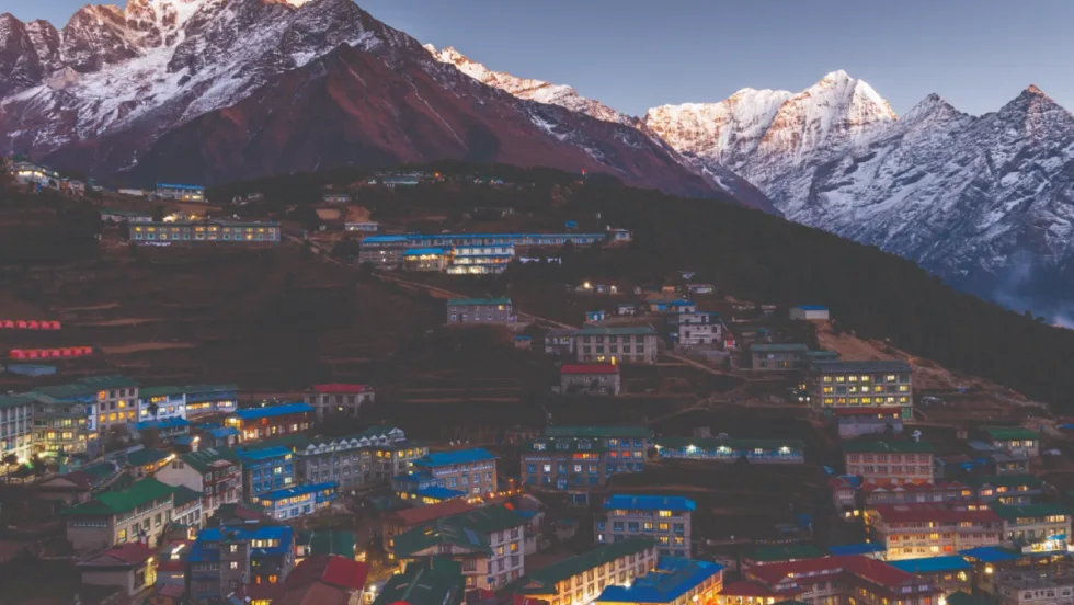 A photo of a Kathmandu region sloped against the foothills of the snow-capped Himalayas.