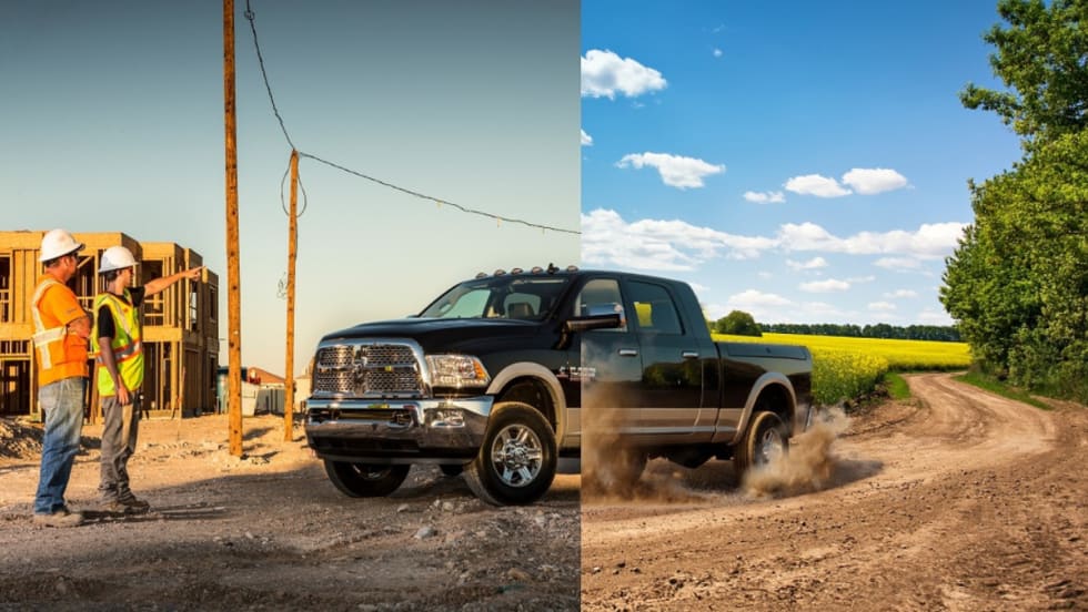 Construction workers look at a 2013 MY Ram truck.