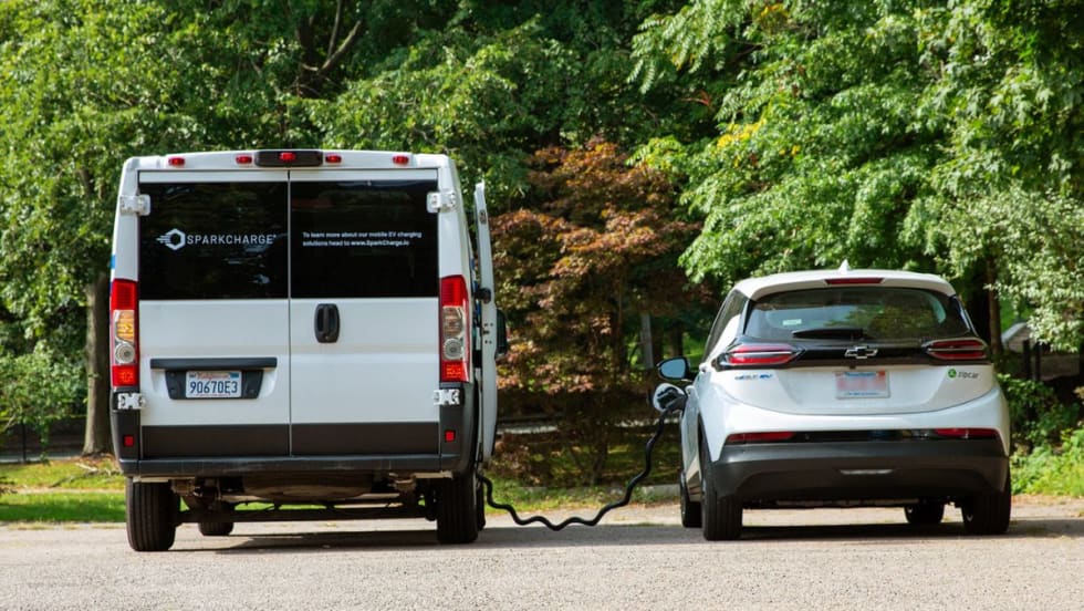Two EVs charging from a mobile unit.