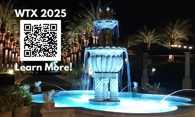 night photo of a water fountain with QR code for information on WTX 2025