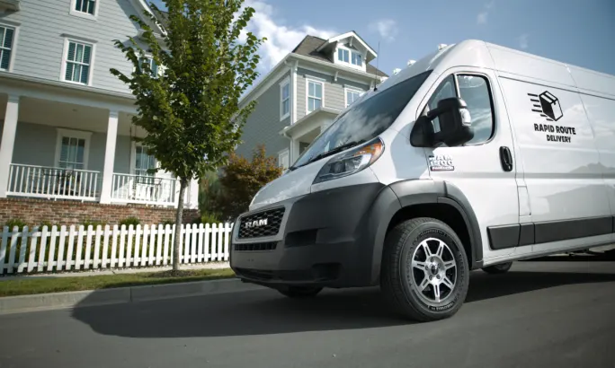Delivery van parked in front of homes.