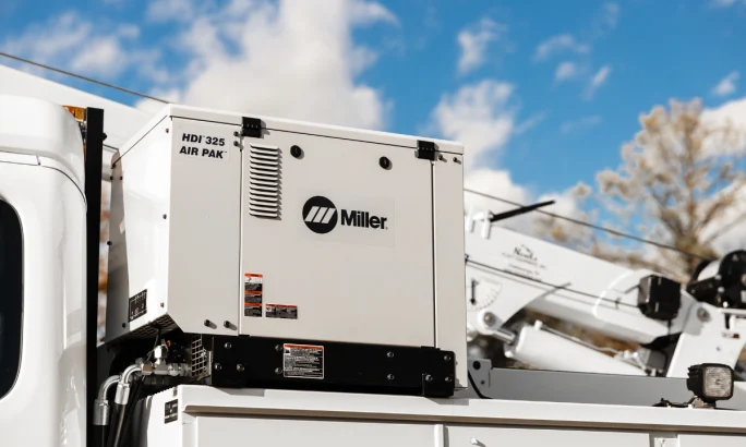 close-up view of a work truck with a Miller Electric combined welder and air compressor.