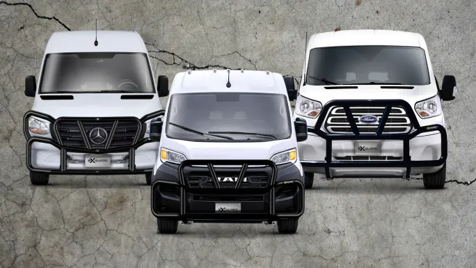 Three commercial vans (Mercedes-Benz, Ram, and Ford) equipped with Ex-Guard grille guards parked side by side.