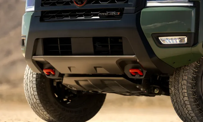 Close-up of 2026 Nissan Frontier PRO-4X skid plate and red tow hooks.