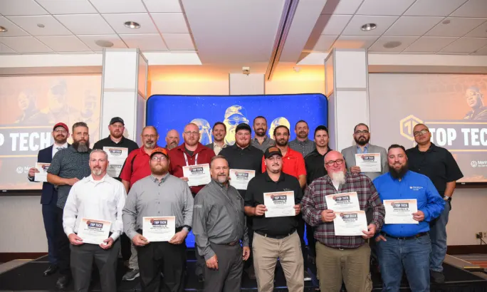 Group photo of Cox Automotive Top Tech 2025 finalists holding certificates on stage.
