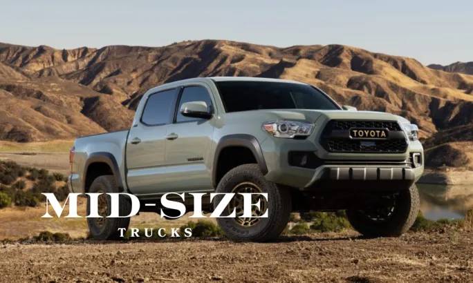 Toyota Tacoma midsize pickup in rugged terrain, highlighting its 73.5-inch bed length that provides balanced hauling and ROI benefits for fleet managers.