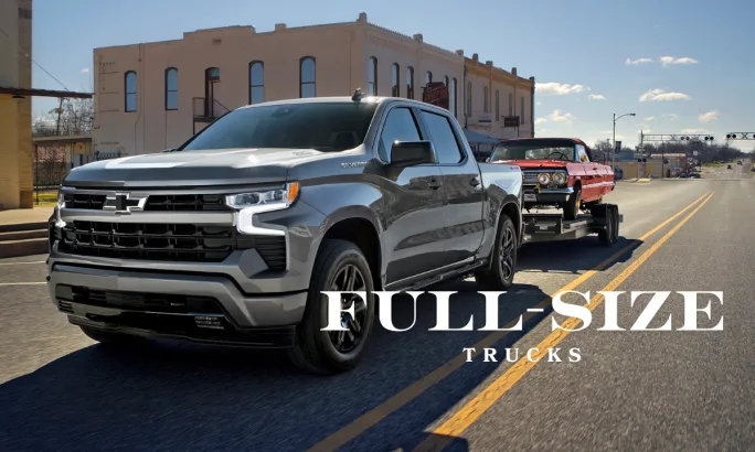 Chevrolet Silverado 1500 full-size pickup towing a trailer, showcasing the 98.2-inch long bed that maximizes hauling and upfit options for fleet operations.