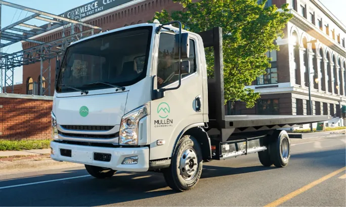 Mullen THREE Class 3 EV chassis cab flatbed truck, part of Bollinger Motors’ expanded fleet lineup with Ziegler and Range Truck Group.