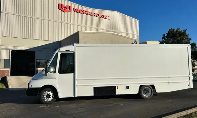 A white Workhorse W56 electric step van parked in front of the Workhorse manufacturing facility in Union City, Indiana.