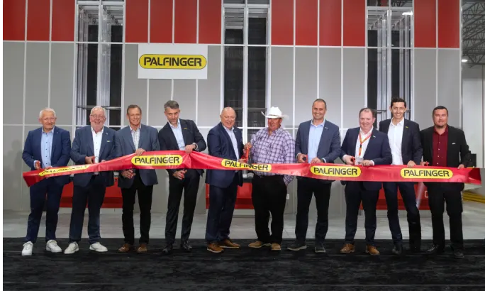 Business leaders cut ribbon to open a PALFINGER facility.