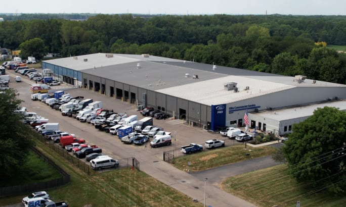 Aerial view of Ford Pro Elite Commercial Service Center with rows of work trucks and service bays.