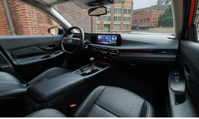 View of the 2026 Nissan Sentra’s cabin, featuring the steering wheel, center console, and dual digital displays on the dashboard.