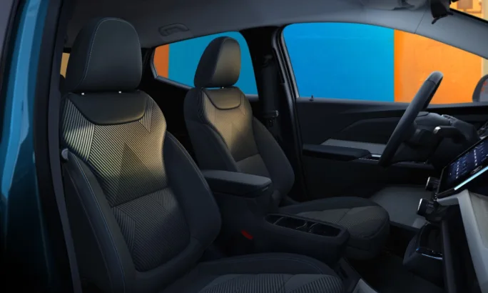 Interior view of 2027 Chevrolet Bolt showing front seats and console design.