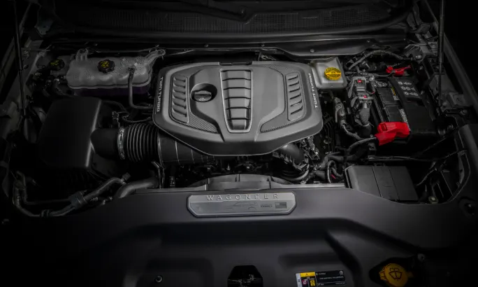 Close-up of the 2026 Jeep Grand Wagoneer’s 3.0L Hurricane twin-turbo engine, showcasing under-hood design and layout.