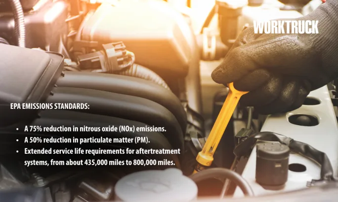 Technician checking engine oil dipstick on a diesel truck as new EPA emission standards tighten requirements for NOx and particulate matter reductions.