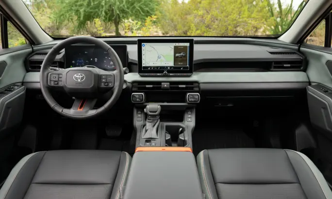 Interior view of the 2026 Toyota RAV4 showing dashboard, steering wheel, and large touchscreen display.