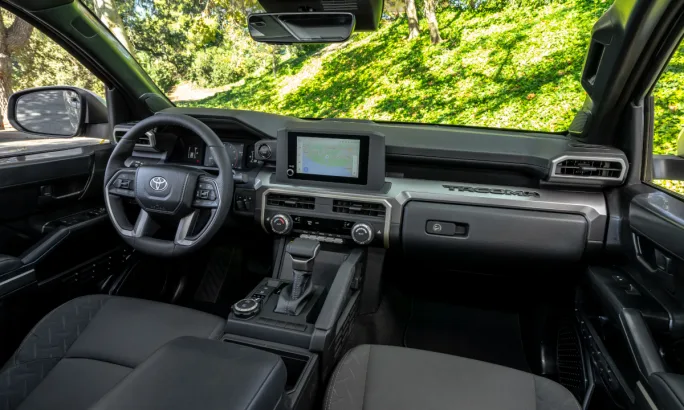Interior photo of a pickup truck looking forward to the dash and steering wheel.