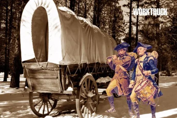 Sepia image of a covered wagon with two Revolutionary-era musicians, symbolizing early American transport and the roots of modern fleet work.