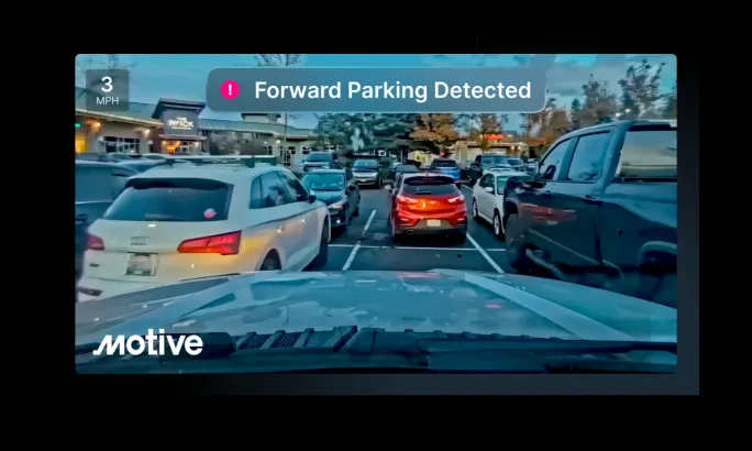 Dashcam view looking forward as a truck pulls into a parking space.