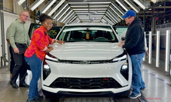 GM employees stand alongside a Chevrolet Bolt on the assembly line at the Fairfax Assembly Plant in Kansas City, Kansas.