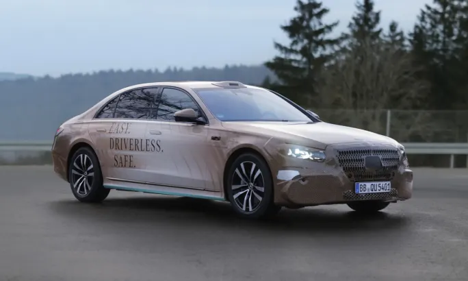 Mercedes-Benz S-Class robotaxi prototype driving on a roadway during autonomous vehicle testing.